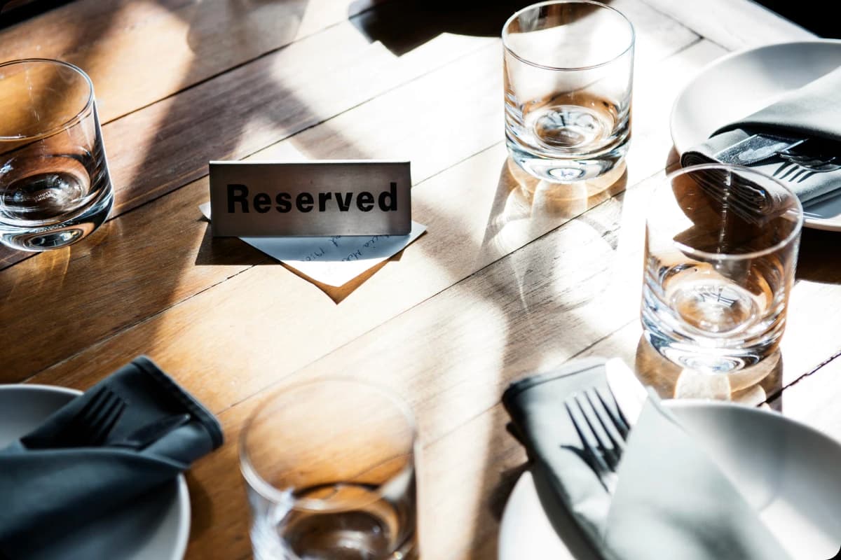 glasses on a table with a reserved sign